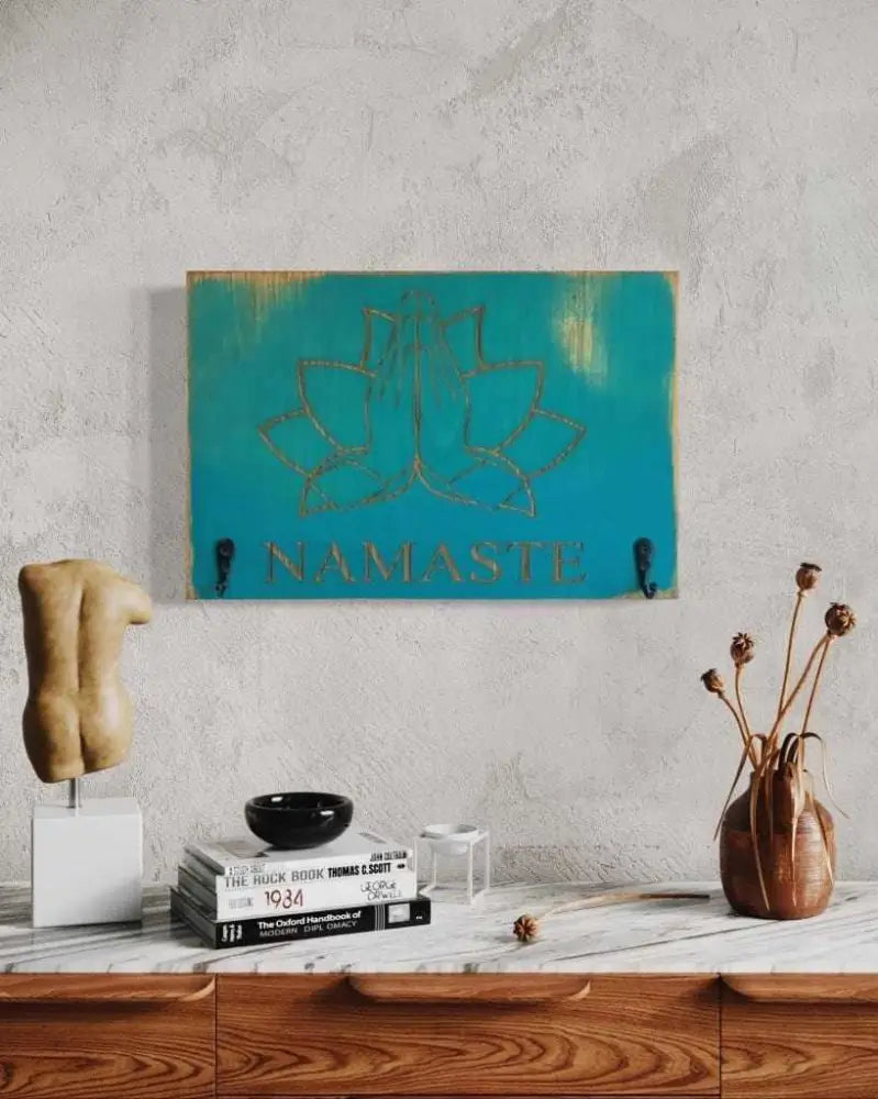 Namaste keychain holder with engraved design in antiqued surf blue wood, ideal for yoga enthusiasts.