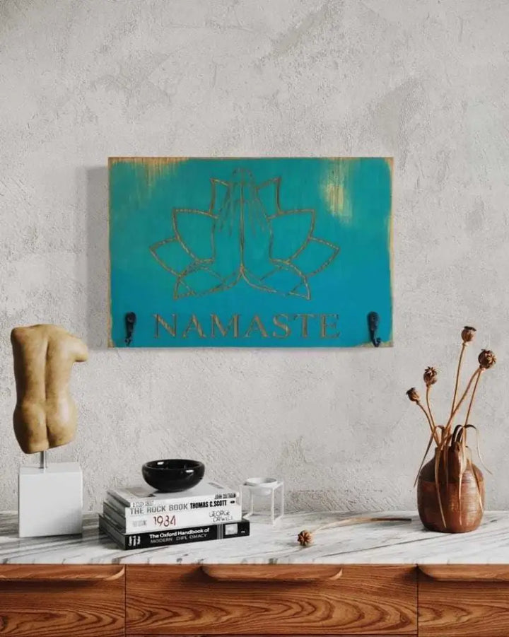 Namaste keychain holder with engraved design in antiqued surf blue wood, ideal for yoga enthusiasts.