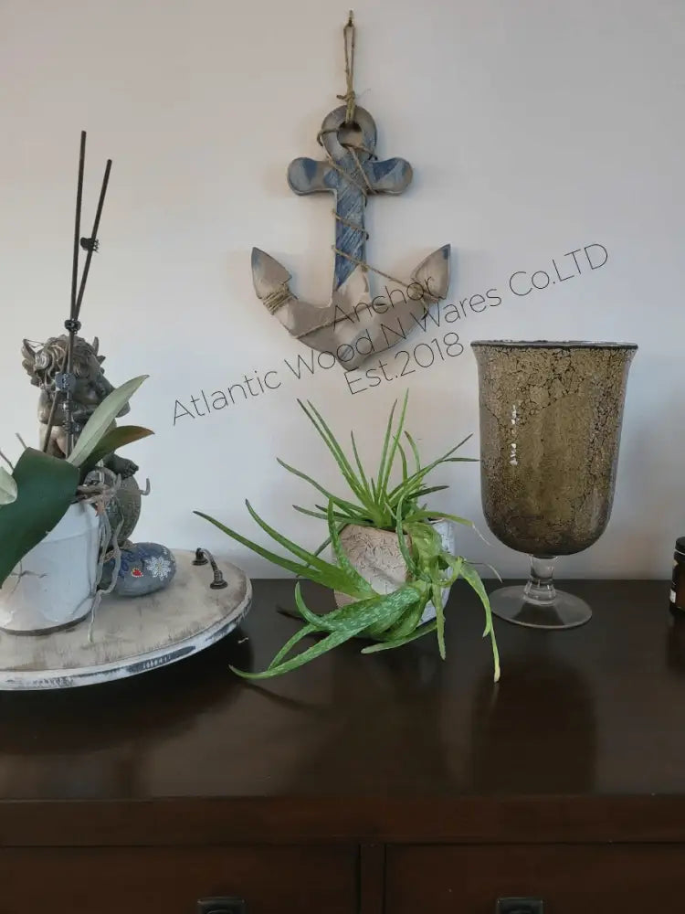 Rustic nautical wooden anchor wall art with weathered look, displayed in home decor setting.