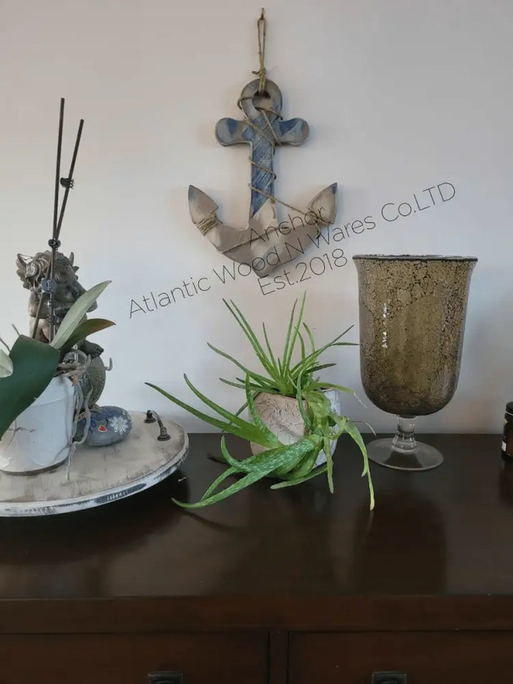 Rustic nautical wooden anchor wall art with weathered look, displayed in home decor setting.