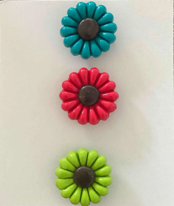 Polyclay Daisy Fridge Magnets in blue, red, and green supporting IWK Foundation.