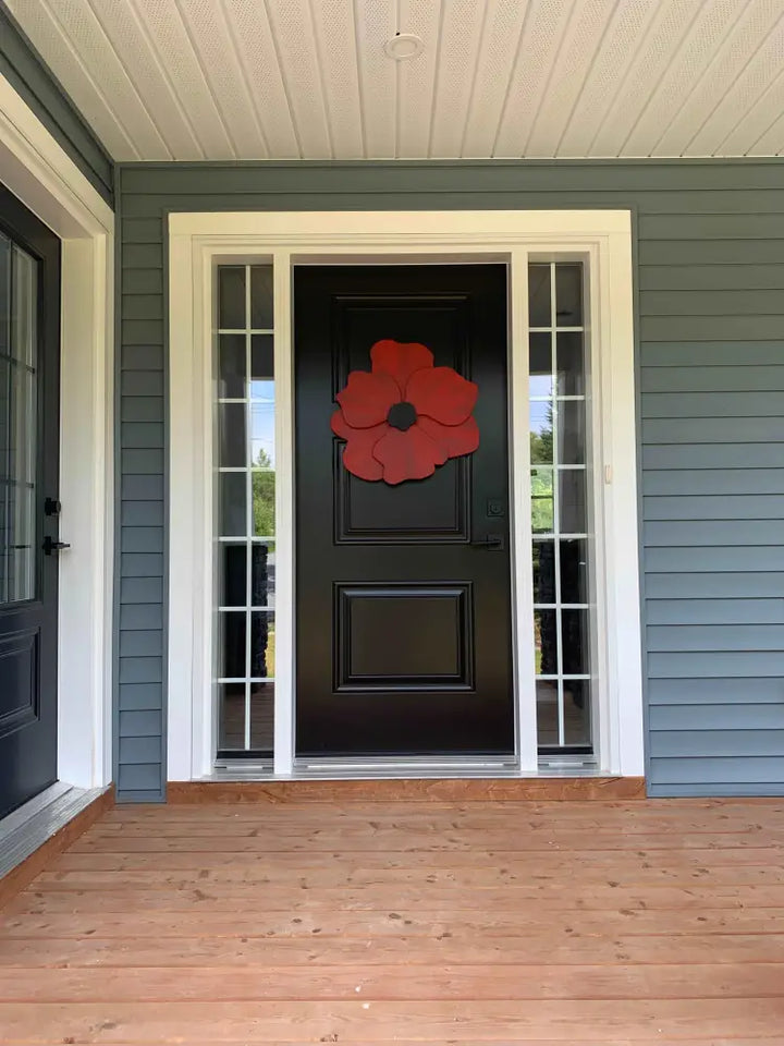 Handcrafted wooden flower door decor on black door, anemone inspired design.