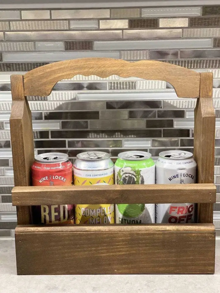 Rustic wooden beer caddy holding four cans, ideal gift for beer enthusiasts.