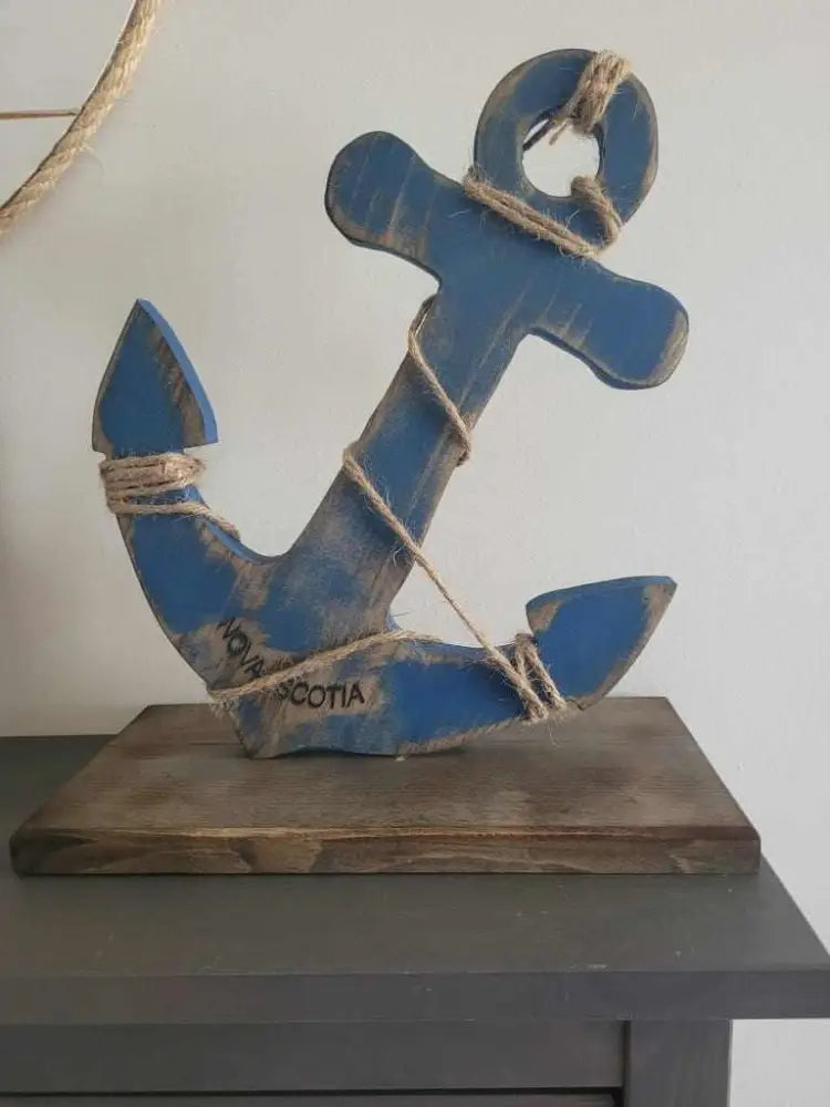 Rustic wooden anchor decor with jute rope, engraved with "Nova Scotia", painted in blue.