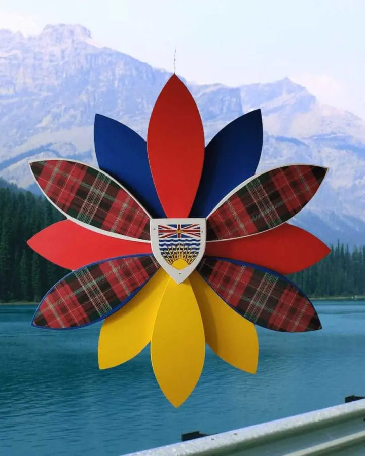 Handcrafted wooden flower art with tartan petals displayed outdoors.