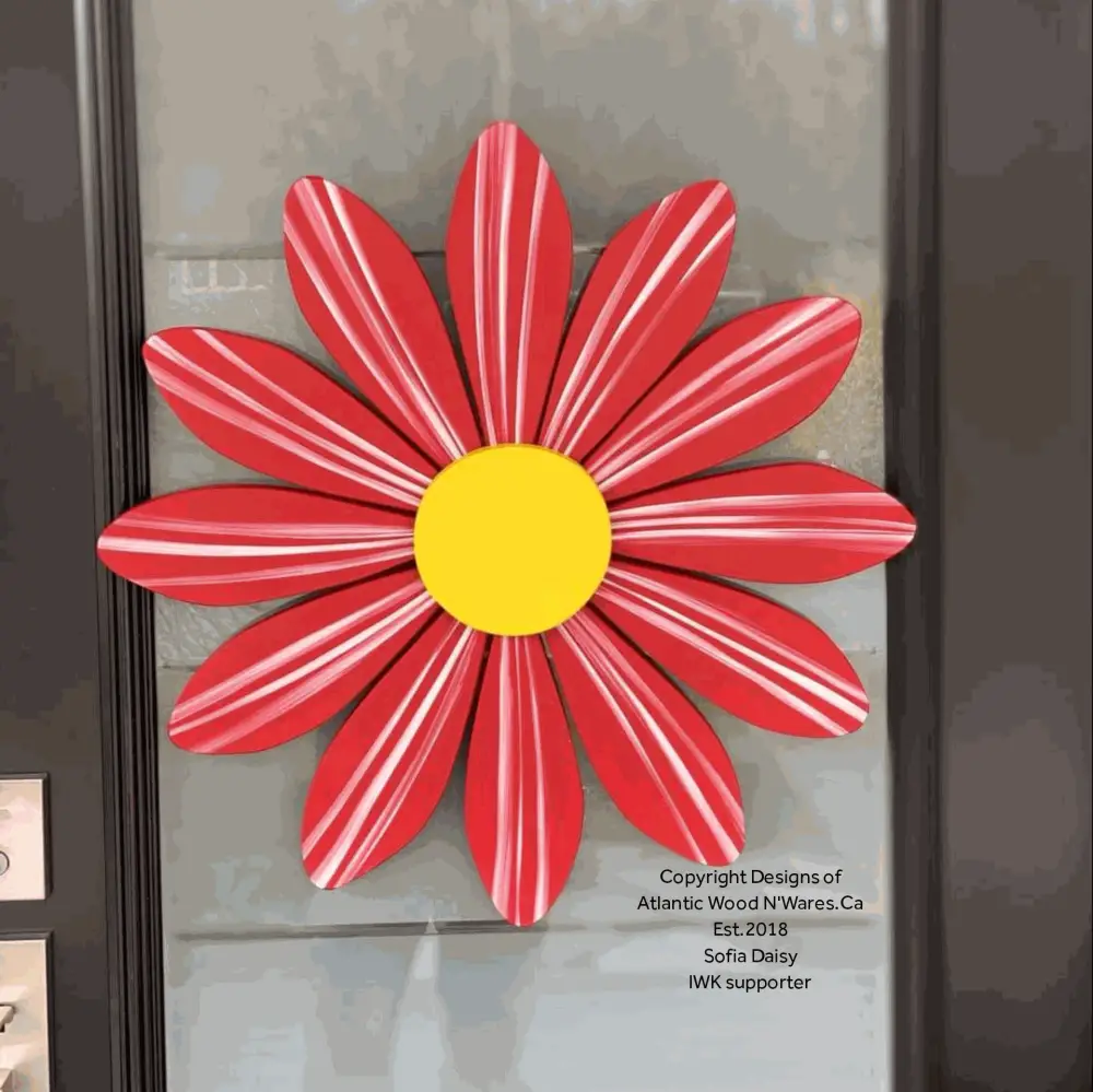 Handmade wooden flower art Sofia Daisy with red petals and yellow center, symbolizing hope and support for heart transplant children.