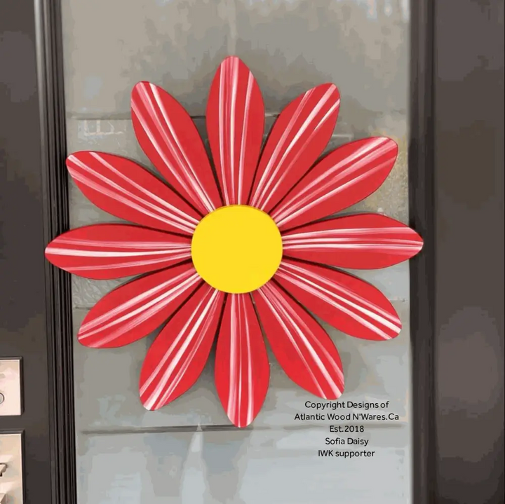 Handmade wooden flower art Sofia Daisy with red petals and yellow center, symbolizing hope and support for heart transplant children.