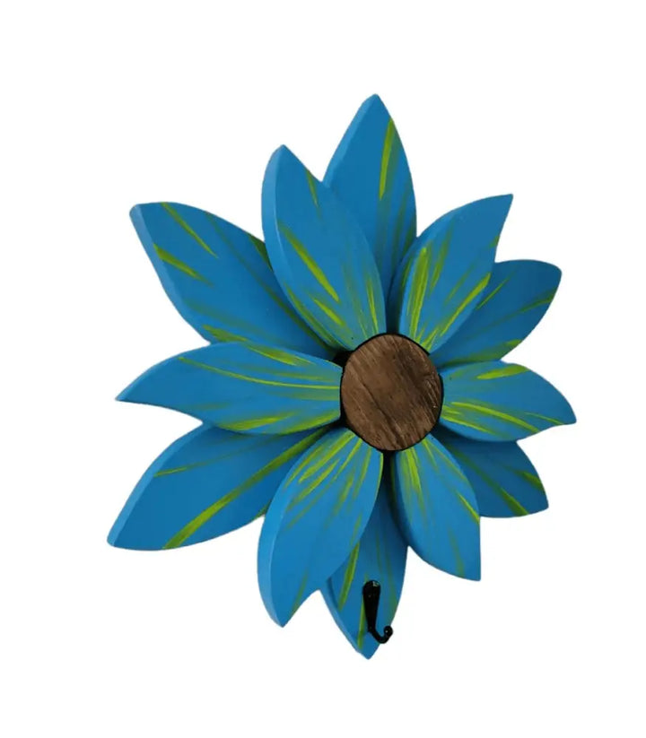 Handcrafted blue flower wall decoration with green accents, made of painted pine petals.