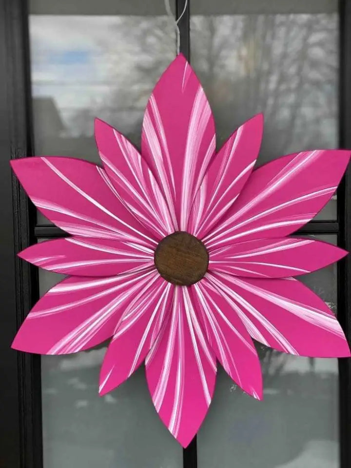 Hand-painted wooden flower door decor in vibrant pink with white accents, featuring a wire hanger for easy installation.