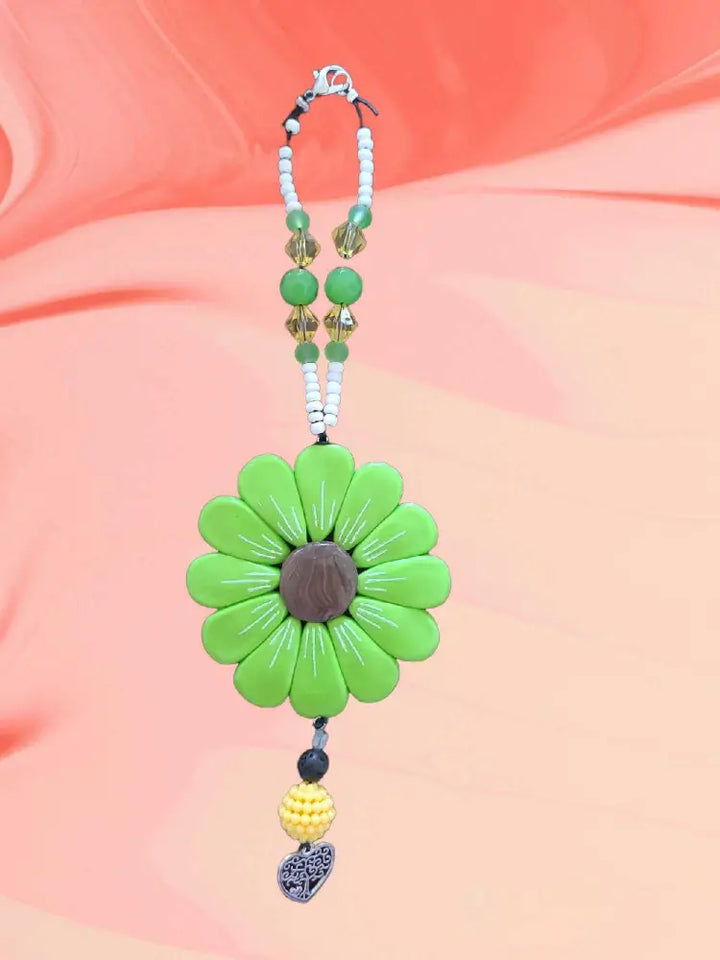 Sofia Daisy Charm with hand-sculpted petals, black lava bead, and glass bead accents, elastic cord 9", supports IWK Foundation.