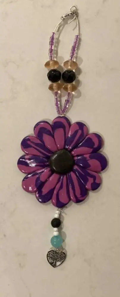 Purple Sofia Daisy car window charm with black lava bead and glass beads on elastic cord, handmade polymer clay flower accessory