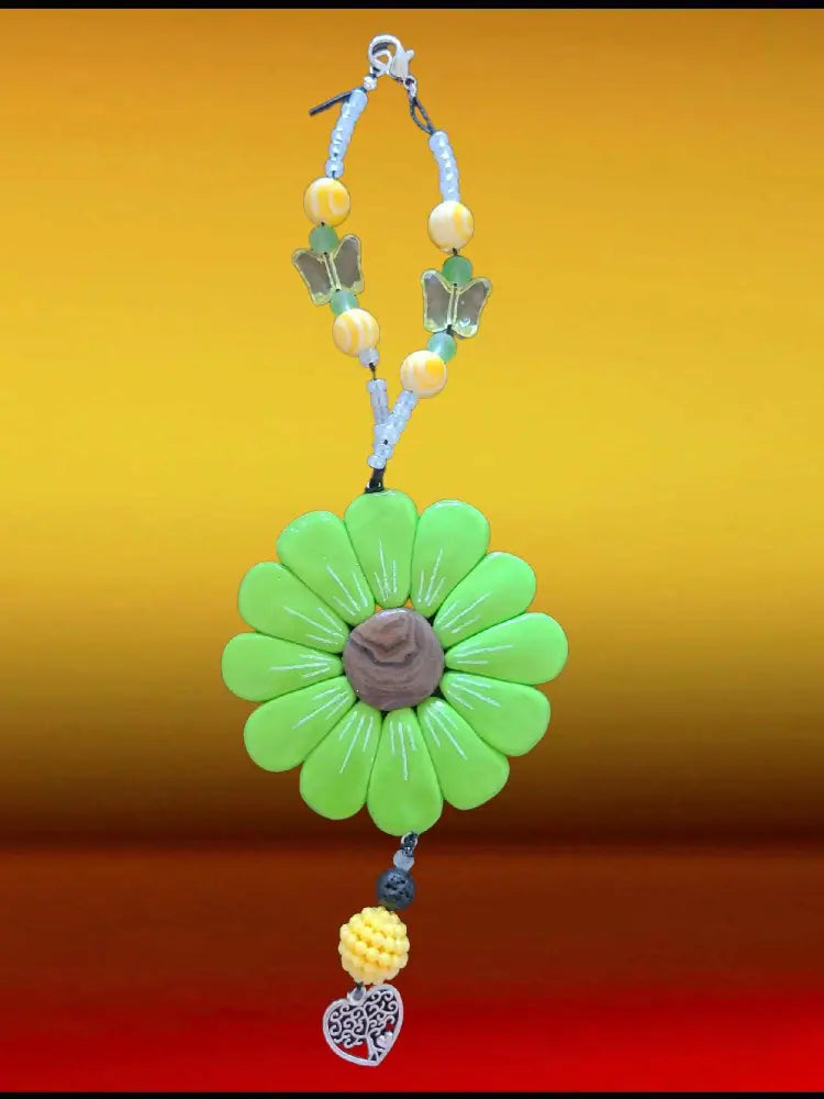 Sofia Daisy Car/Window Charm with green petals, polymer clay design, and beads for IWK Foundation support.