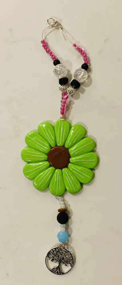 Sofia Daisy car and window charm with green petals, black lava bead, and colorful glass beads.