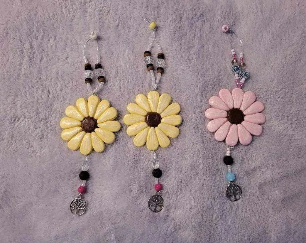 Sofia Daisy Charms with hand-sculpted polymer clay petals, glass beads, and lava bead, supporting IWK Foundation.
