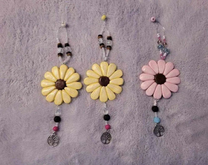 Sofia Daisy Charms with hand-sculpted polymer clay petals, glass beads, and lava bead, supporting IWK Foundation.