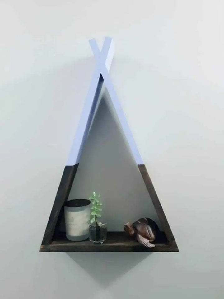 Handcrafted wooden teepee shelf with decorative items displayed.