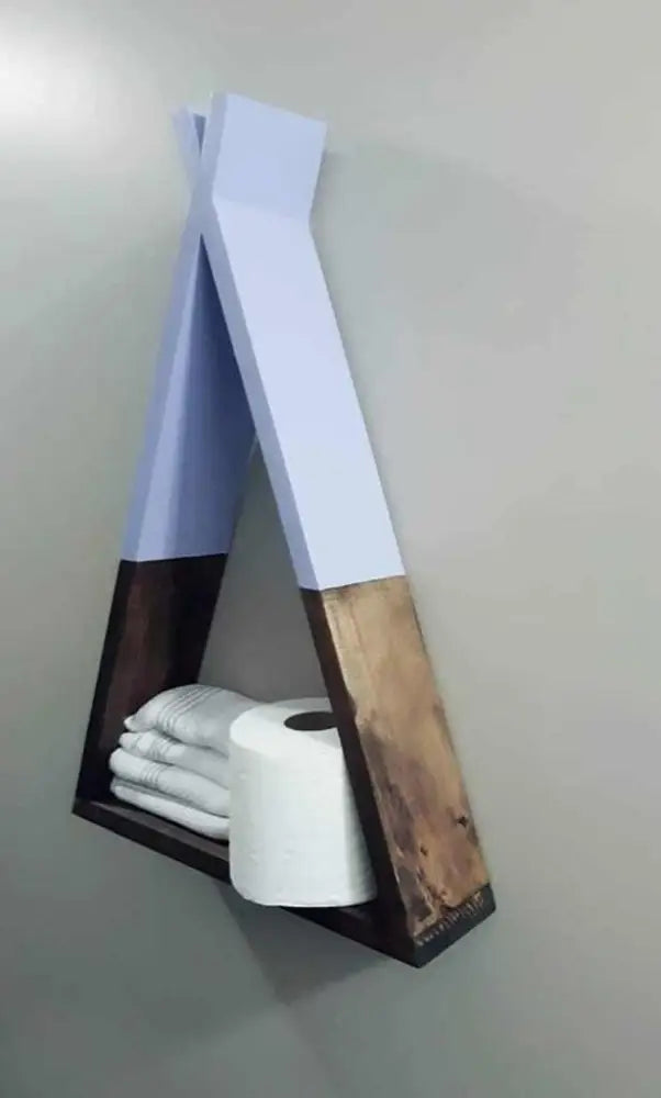 Handcrafted wooden teepee shelf for home decor, displaying towels and toilet paper.
