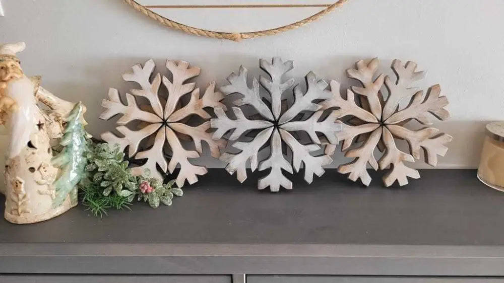 Handmade wooden snowflake decorations on display.