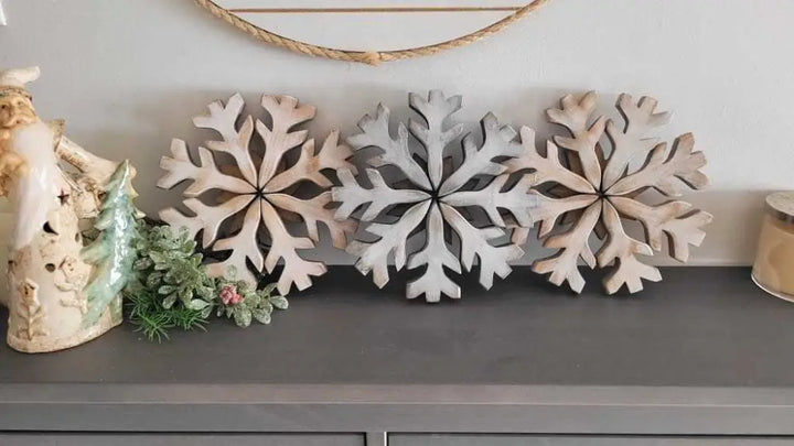 Handmade wooden snowflake decorations on display.