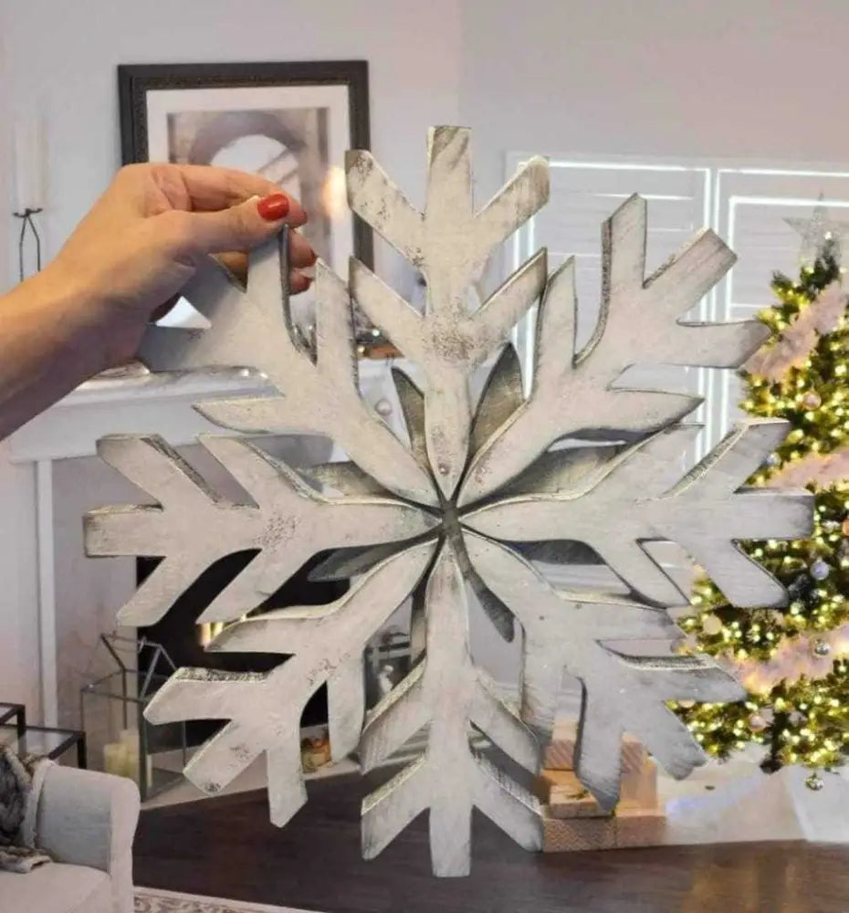 Handmade rustic snowflake decoration with galvanized wire hanger, perfect for winter door charm.