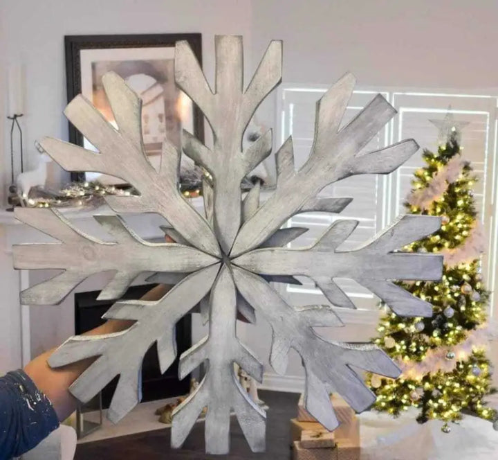 Handmade wooden snowflake decoration with rustic charm, perfect for winter home décor.