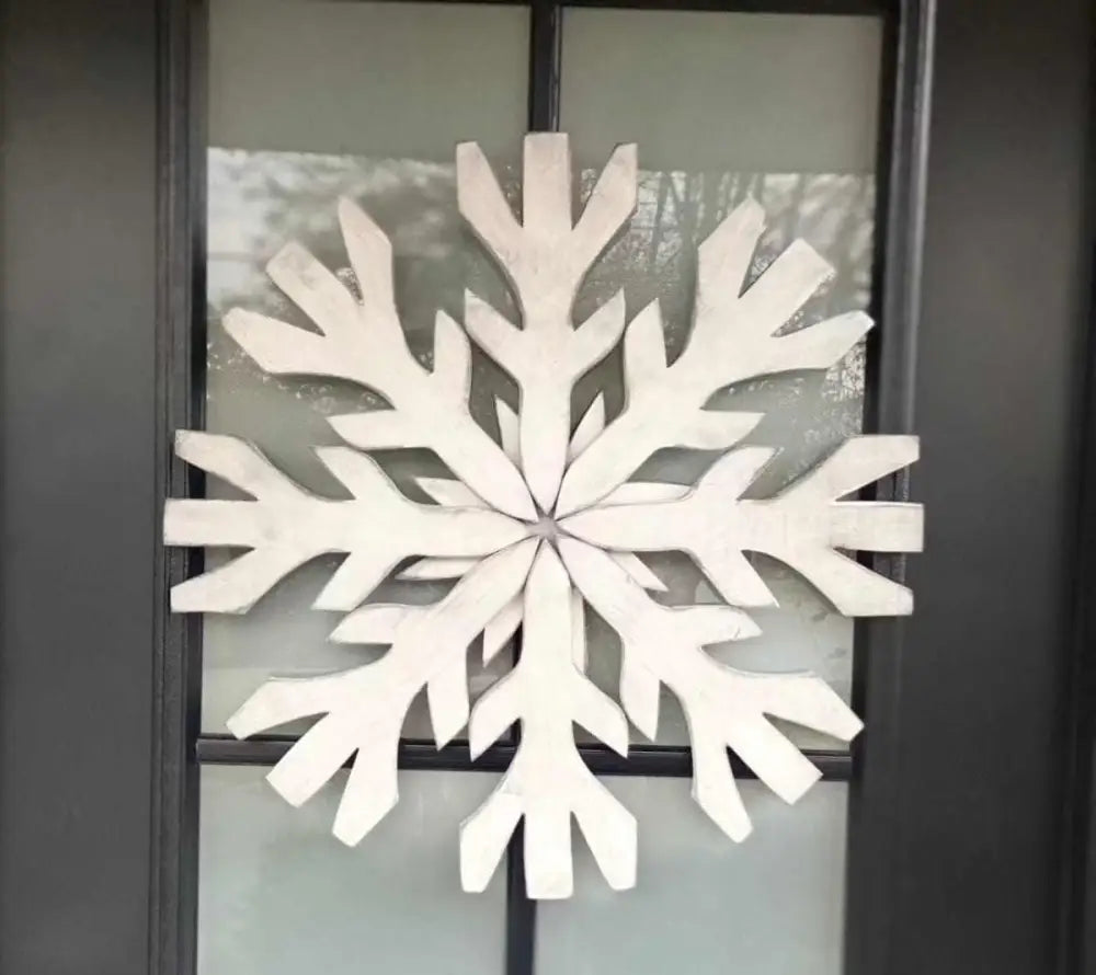 Handmade pine wood snowflake decoration on door.