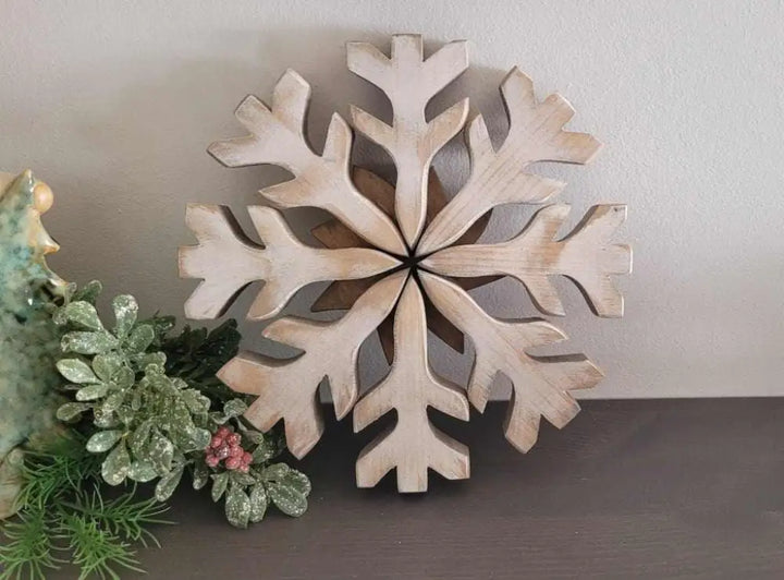 Handmade wooden snowflake decoration with rustic charm, ideal for winter door decor.