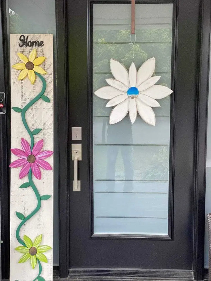 Wooden flower decoration with blue resin center hanging on door, handcrafted by Woodnwares Nova Scotia.