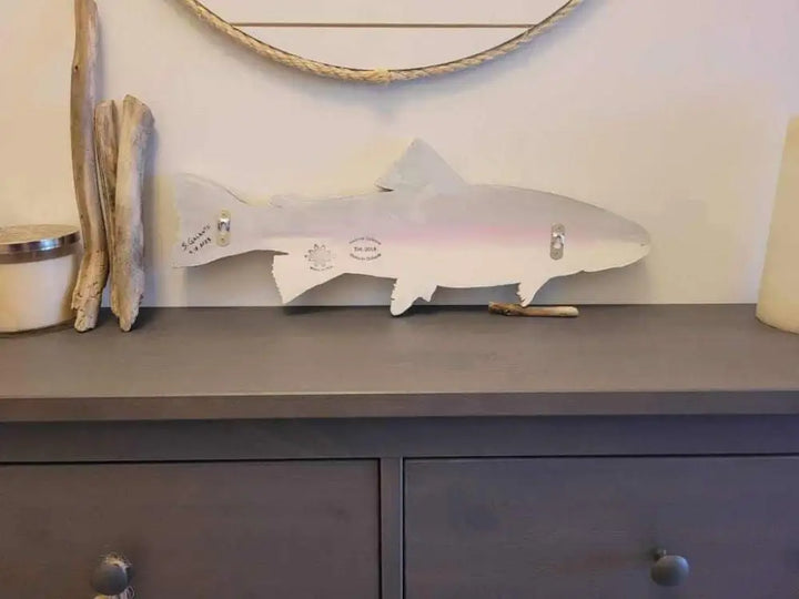 Vibrant rainbow trout wall art in pine wood with hand-painted details, 20 inches by 7 inches, for easy wall mounting.