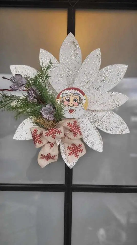 Christmas wooden flower door decoration with hand-painted petals, pine branches, and a festive bow.
