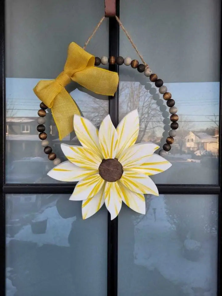 Boho style wooden bead wreath with a painted wood flower and hand-stained beads.