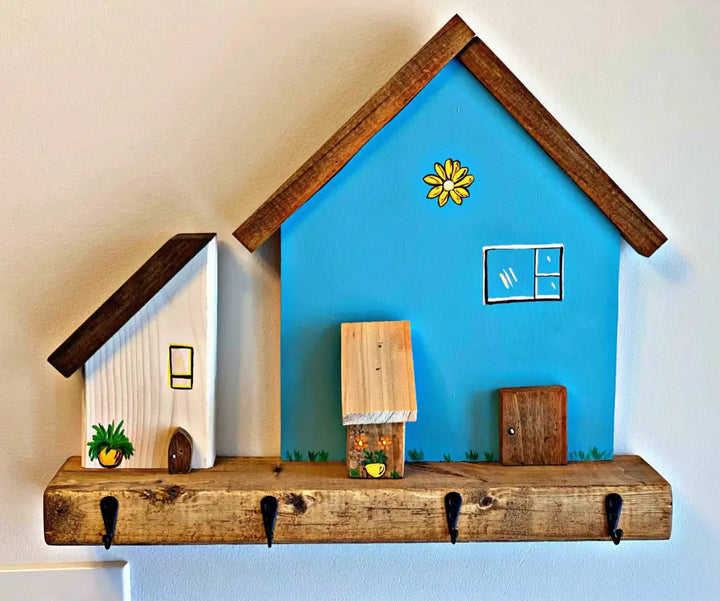 Handmade wooden village house key chain holder with hooks, rustic decor.