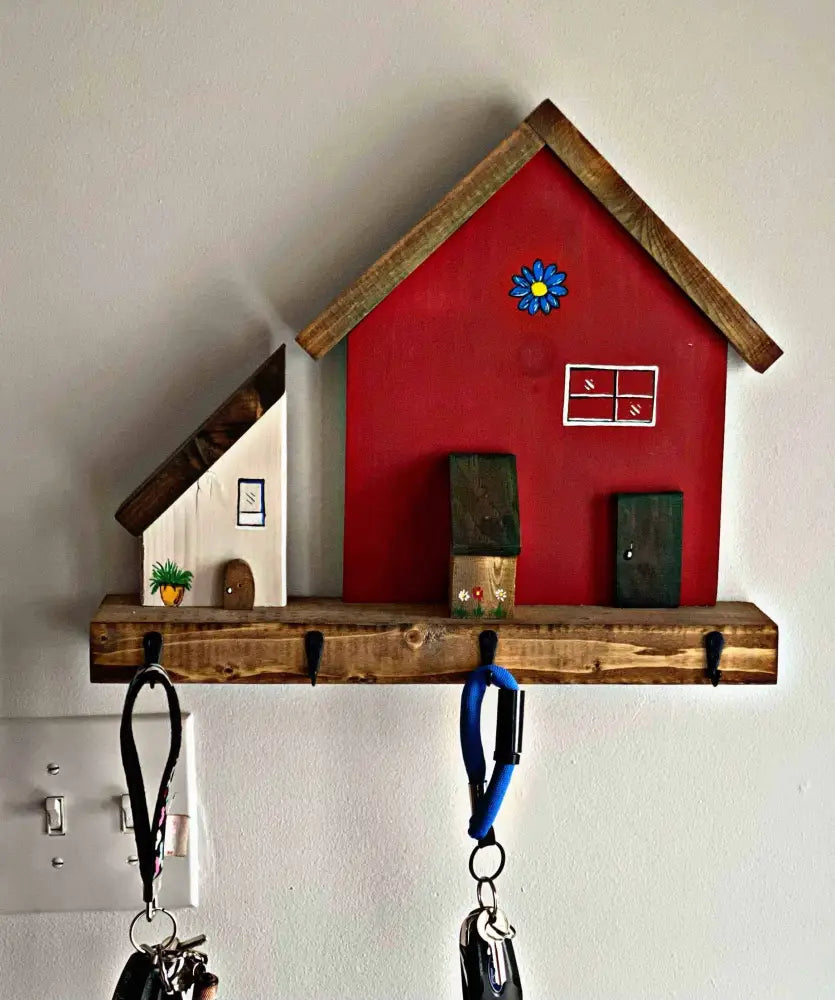 Handmade wooden village house key chain holder with hooks, rustic wall decor.