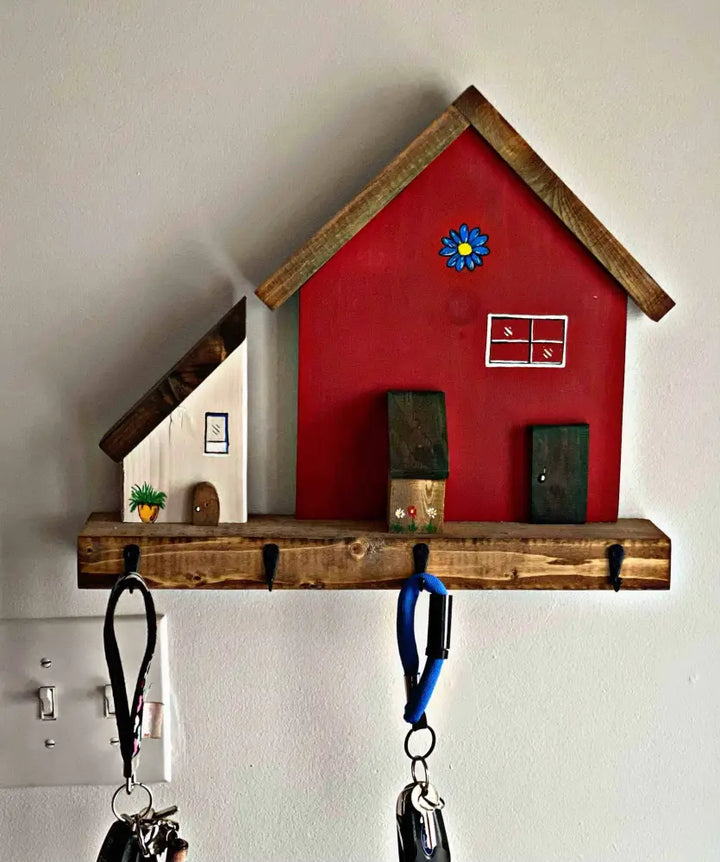 Handmade wooden village house key chain holder with hooks, rustic wall decor.