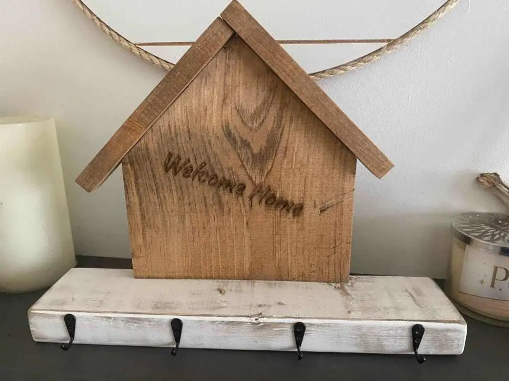 Handmade wooden key chain holder with rustic village house design and hooks.