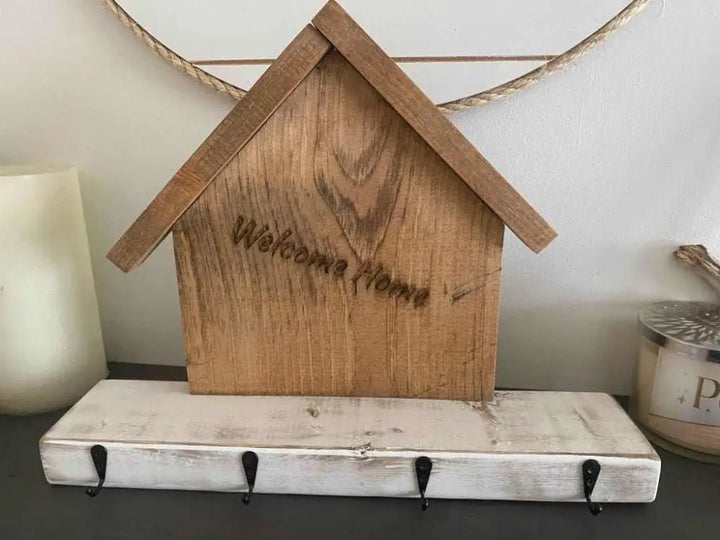 Handmade wooden key chain holder with rustic village house design and hooks.