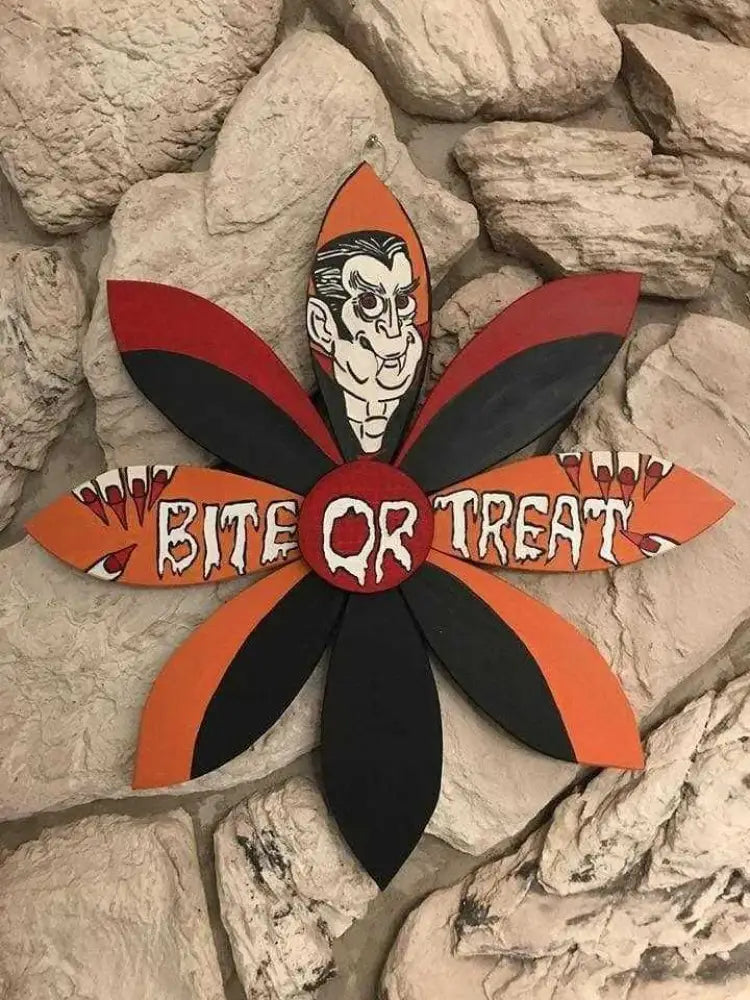 Wooden flower Dracula Halloween decor with "Bite or Treat" message in vibrant colors.